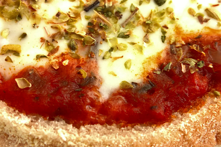 Close up of a muffin pizza.