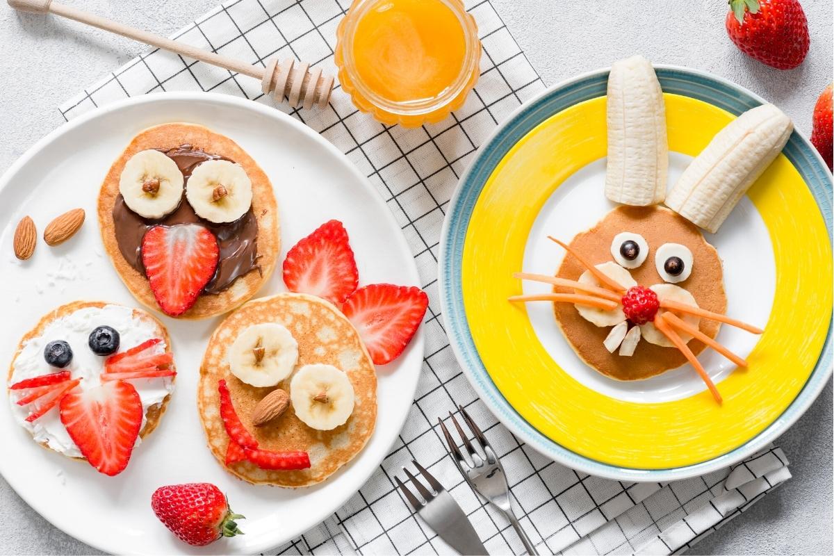 Funny faces made of pancakes and fruit.