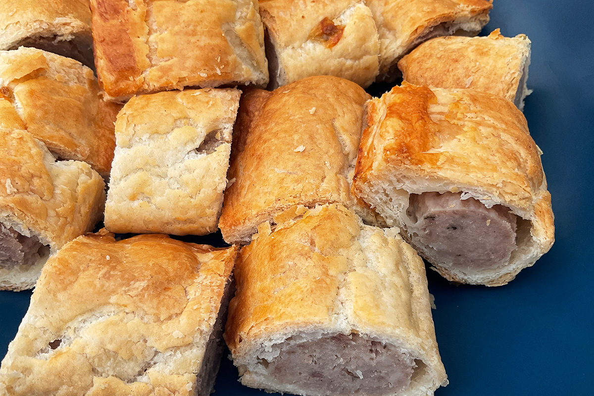Sausage rolls cut into small pieces as party appetizer.