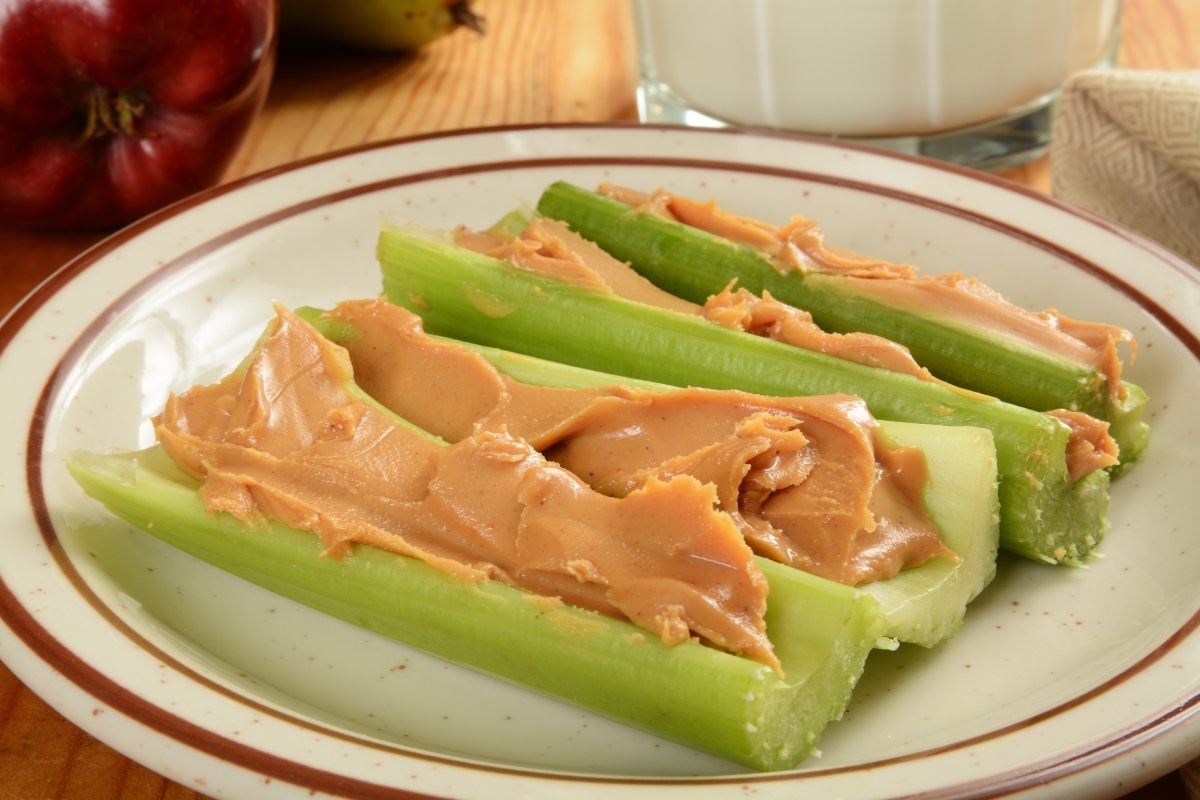 Three celery boats with peanut butter.
