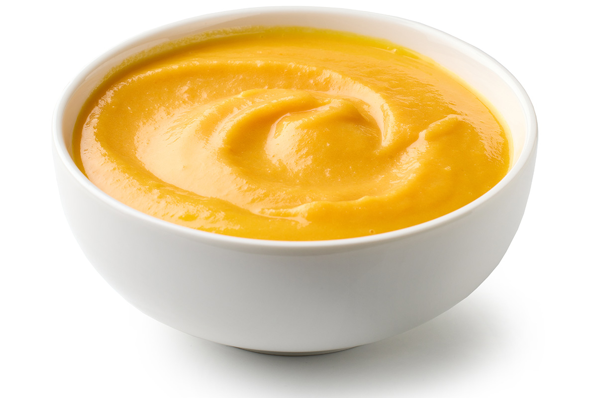 A bowl with potato and carrot soup.