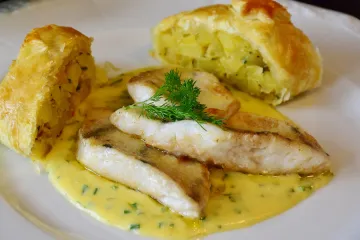 Pescado a la plancha con salsa de mantequilla y cebollino.