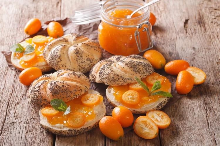 Mermelada de kumquat en un tarro y bocadillos dulces.