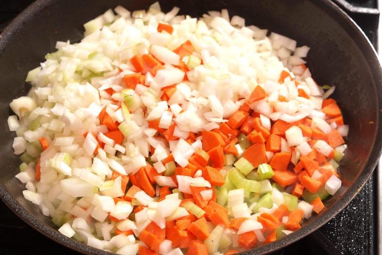 Mirepoix con cebolla, zanahoria y apio cortados en brunoise.