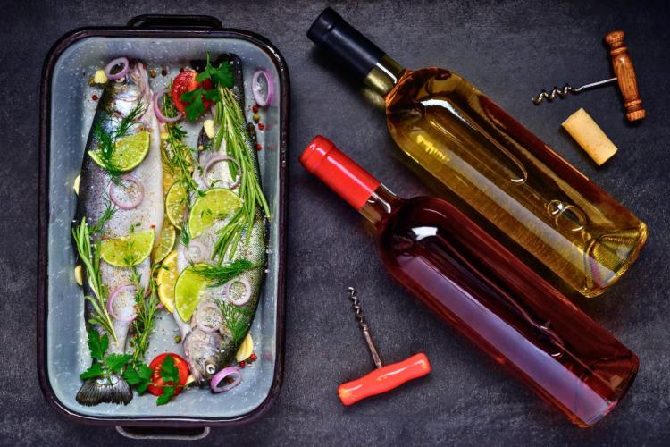 Vino y pescado que está  listo para el horno.