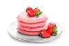 Una pila de tortitas rosadas con fresas.
