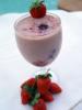 Batido de fresa servido en copa y decorado con fruta fresca.